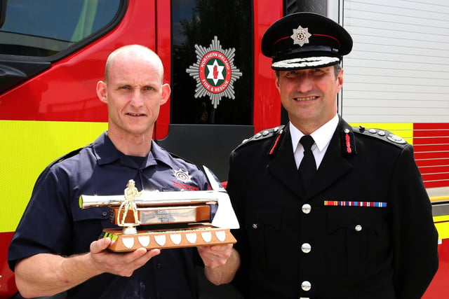 Gareth Weir, from Cookstown, who was awarded the Top Trainee Award for achieving the highest standard throughout the course and interim Chief Fire & Rescue Officer, Andy Hearn.