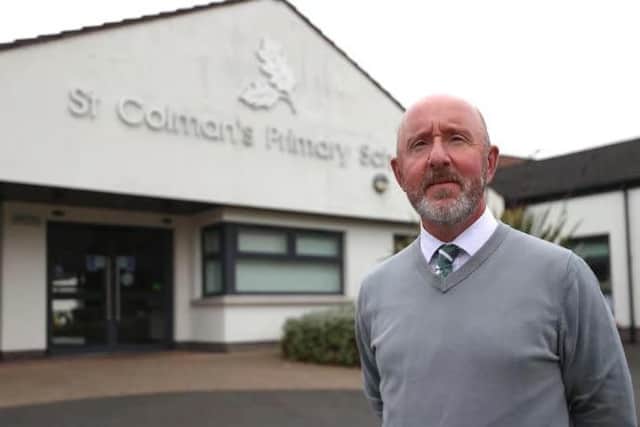 Principal Stephen Baine outside St Colman's Primary School in Lambeg, which received a threatening email on Monday morning. Picture: Liam McBurney / Press Association