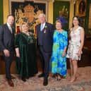 Robin Mercer BEM is pictured with Lord Lieutenant Dame Fionnuala Jay-O'Boyle DBE, at a ceremony in Hillsborough Castle, where he was presented with the British Empire Medal. He is joined by his wife Edith, son Alan and his wife Ciara. Pic credit: Aaron McCracken