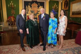 Robin Mercer BEM is pictured with Lord Lieutenant Dame Fionnuala Jay-O'Boyle DBE, at a ceremony in Hillsborough Castle, where he was presented with the British Empire Medal. He is joined by his wife Edith, son Alan and his wife Ciara. Pic credit: Aaron McCracken