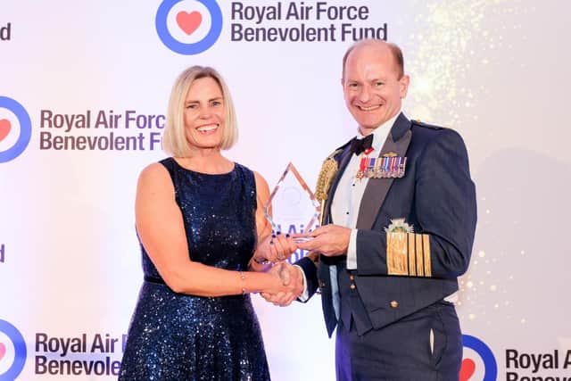 Julie Corbett receiving the Above and Beyond Award from Air Chief Marshal Sir Mike Wigston.