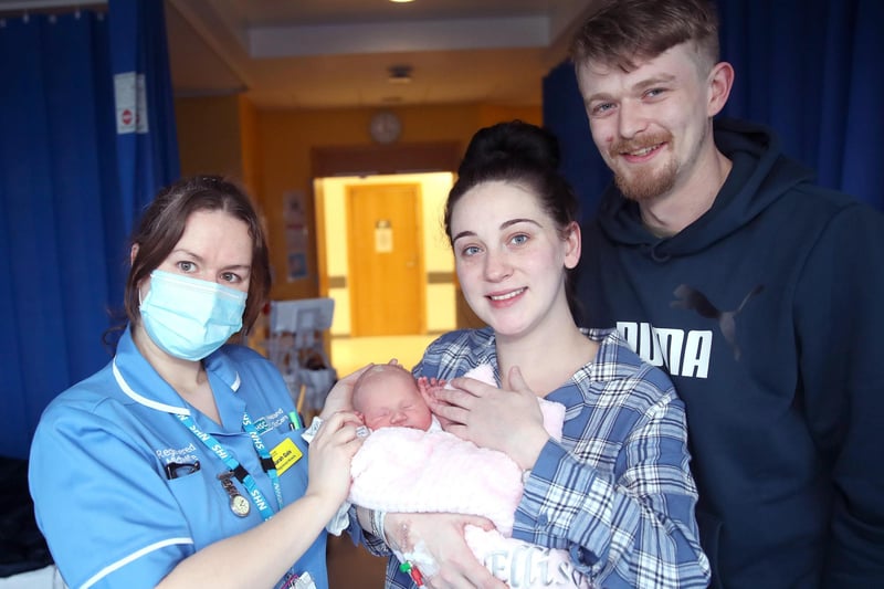 Baby Margo Amelia-Rose Ellison was born at 3.11 am on January 1, weighing seven pounds and one ounce.  Proud parents Jonny Ellison and  Leanne Stewart are pictured with midwife Sarah Gale, in the Ulster Hospital, Dundonald. Picture: Declan Roughan / Press Eye