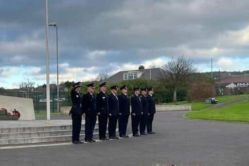 Member of the NIFRS paying tribute to Mr Green at Whitehead War Memorial. Photo submitted