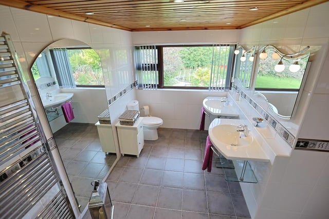 The master bedroom has a superb en suite featuring walk-in shower, his and her sinks, low flush WC and a towel radiator. The walls and floor are fully tiled.