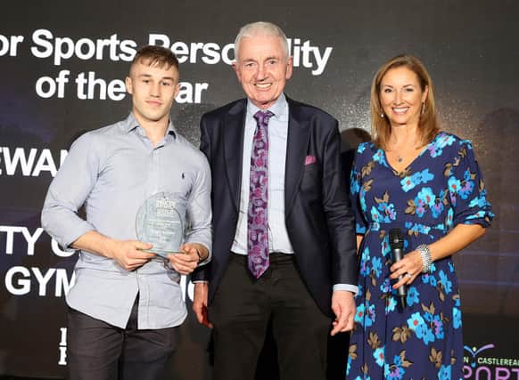 Ewan McAteer from City of Lisburn Salto Gymnastics Club is presented with the Senior Sports Personality of the Year Award by Michael Drayne from sponsor Draynes Farm.