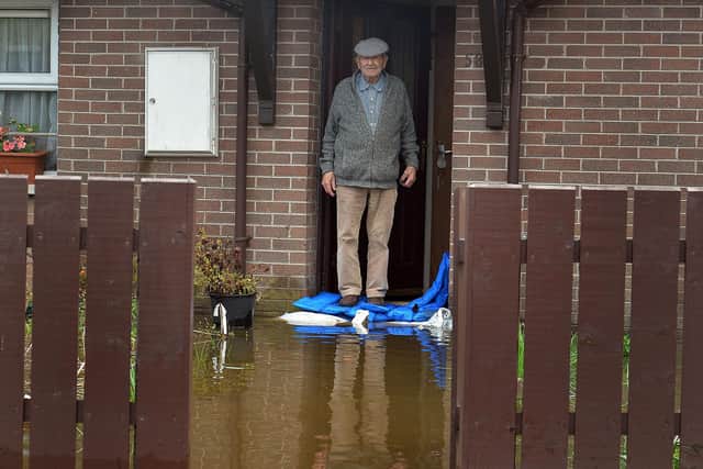 Park Road resident, Brendan McCann was hoping sandbags would keep the water out of his home after the street flooded last week in Portadown, Co Armagh. PT44-258.