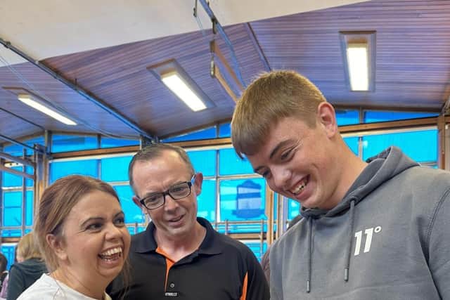 Eoin Bell head boy opening his results alongside his mum and dad.