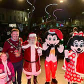 Pictured at the 2022 Christmas switch-on in Lisburn are Mayor Councillor Scott Carson and his daughter with Santa, Mickey and Minnie Mouse on the stage. Picture: LCCC