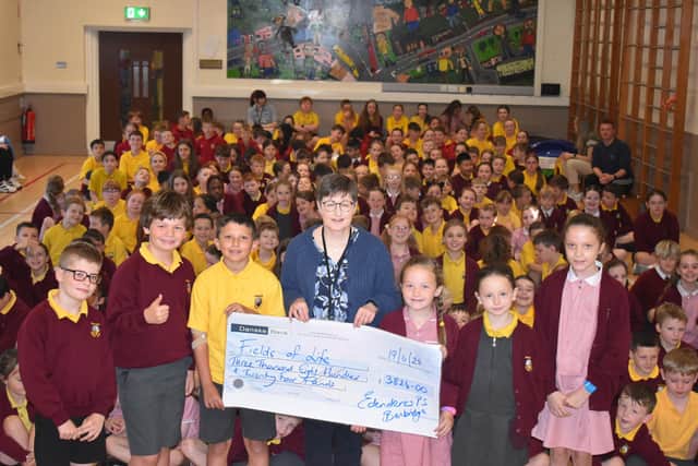 The cheque presentation to Fields of Life charity.
