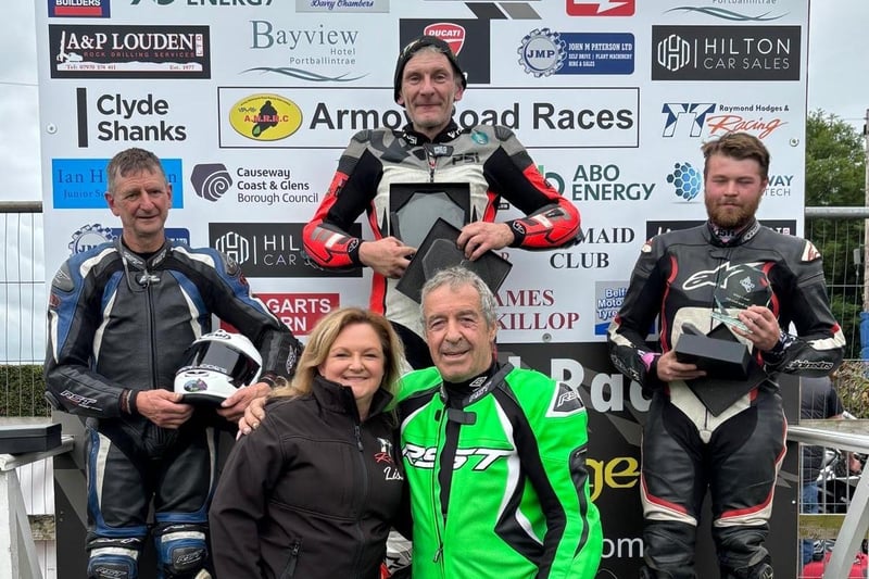 Raymond Hodges and Lisa Ross from TT Racing, pictured with the prize winners of the Moto 3 race.