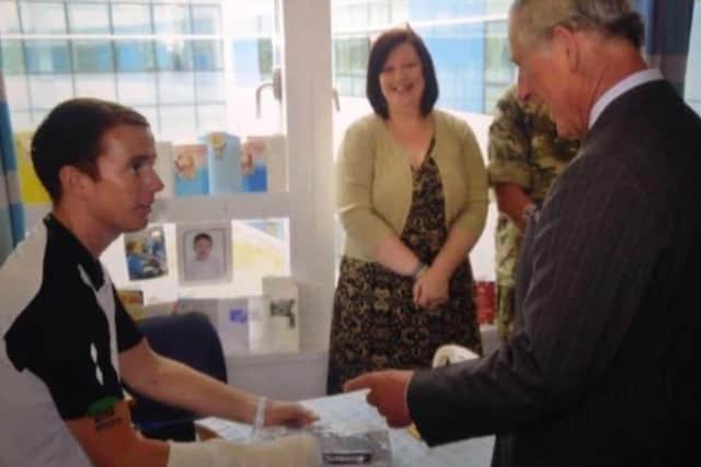 King Charles III presented Bryan with an iPad.