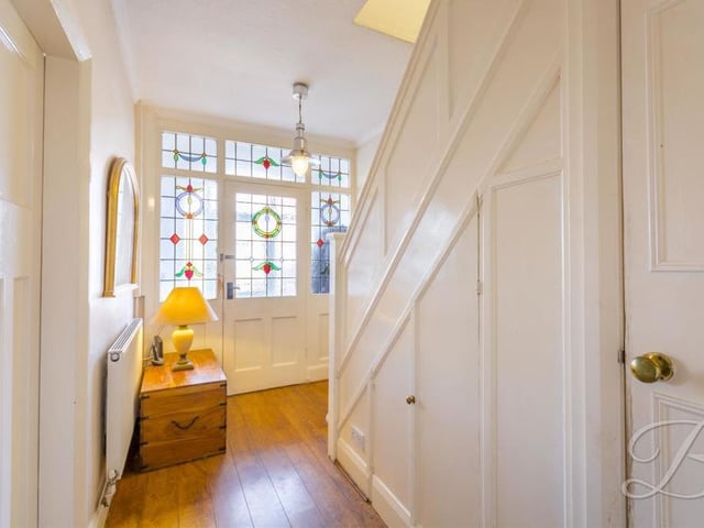 As we prepare to go up to the first floor, we get the chance to have a quick look at the welcoming reception hallway. It features a cupboard for additional storage.