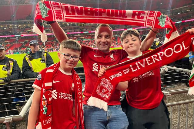 TAKE IT AS RED...Local businessman Ben Graham, along with sons Olly and Eli, cheering Liverpool to a dramatic win against Chelsea.
