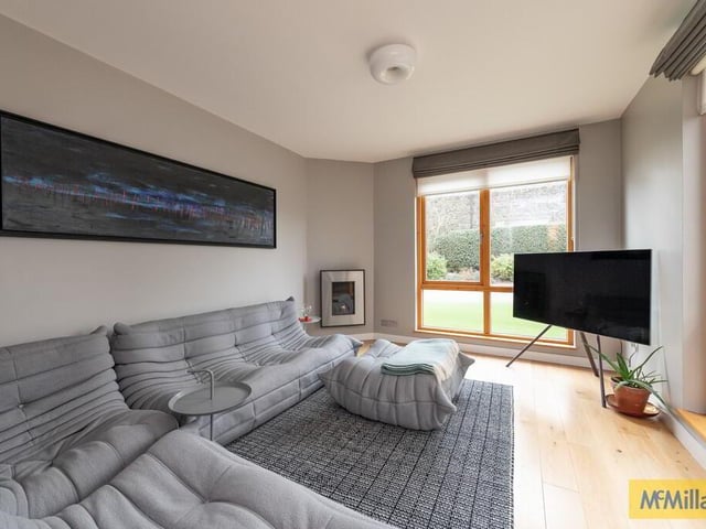 Lounge with polished wood flooring and gas fire.