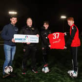 Pictured (L-R) is Power NI’s Barry Rogan, Head Coach Karl Wells, and two Under-15 players.