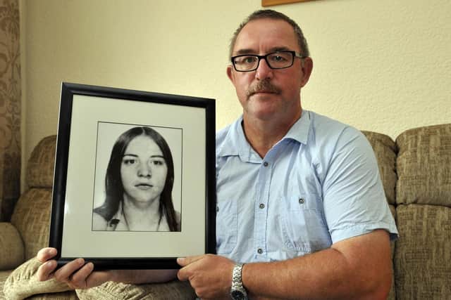 Gerard Beattie with a photograph of his late sister, Marian. INPT32-100gc