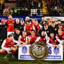 Larne celebrate victory in the County Antrim Shield final after beating Glentoran at Seaview
