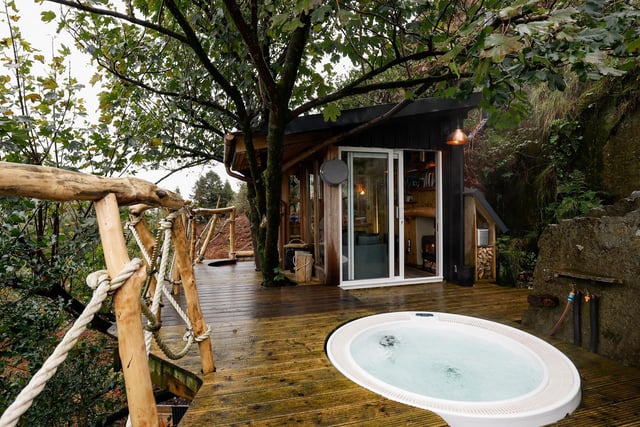 One of the most luxurious and unique Airbnbs in Northern Ireland is Balance Treehouse. 
Located on the side of a mountain and surrounded by natural beauty at Slieve Gullion's foot, this Airbnb is high in the treetops, inviting you to reconnect with nature. 
This staycation showcases a natural look with a fully modern set-up. What makes this stay so unique is that the treehouse is only accessible via a private rope bridge, and the house itself can be controlled by voice commands. 
Complete with a hot tub, an outdoor shower built for two, a super king bed, and an outdoor hammock net for you to spend the evening gazing at the stars, this is a must-visit for anyone searching for a unique staycation. 
For more information, go to discovernorthernireland.com