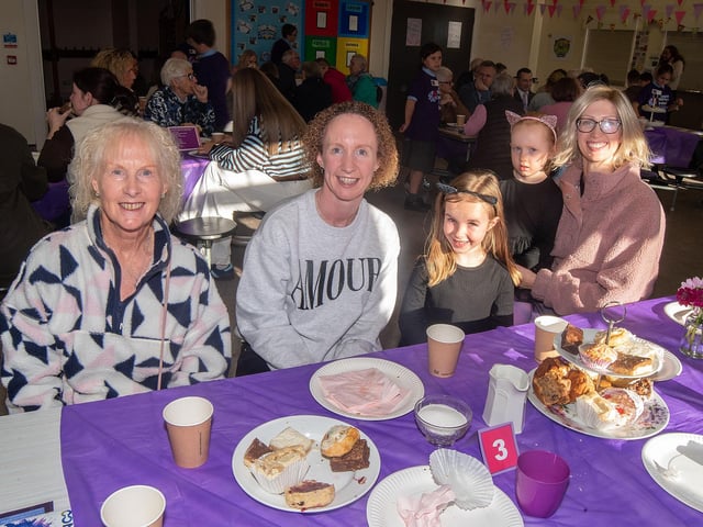 Smiling for the camera at the charity coffee morning are from left, Rosemary Montgomery, Lynn Burns, Rachel McCullough (5), Anna McCullough (4) and mum, Claire.