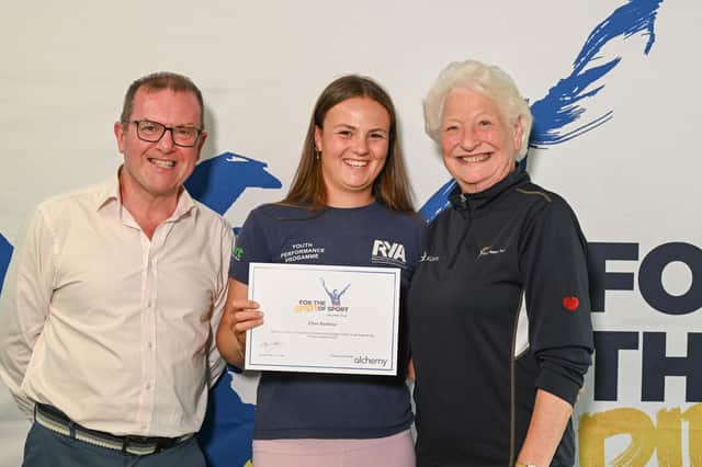 Sailor Ellen Barbour from Whitehead receiving her Mary Peters Trust award certificate from Barry Funston and Lady Mary Peters. Photo submitted by Mary Peters Trust