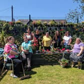 Staff, volunteers and project participants at Atlas Women’s Centre enjoying the good weather at the centre’s garden Image: Contributed by Atlas Women's Centre