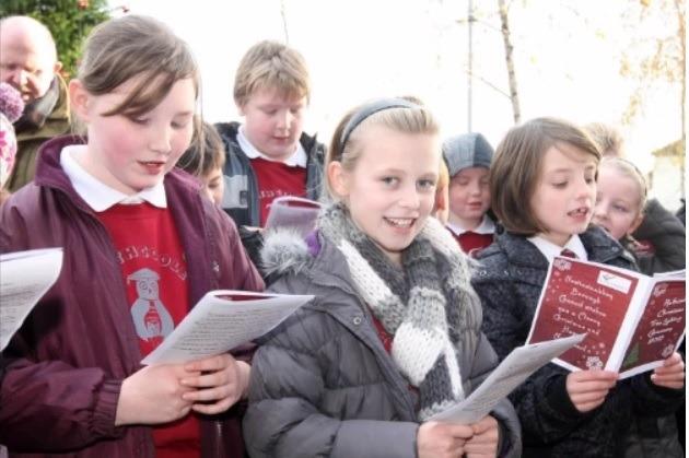 Pupils from Rathcoole PS singing carols at the estate's Christmas tree switch on event in 2010.