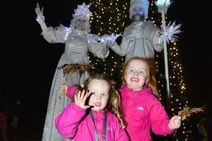 Sisters Rose and Faye McGovern with the event’s Ice Characters, pictured at the Hazelbank Christmas tree.