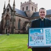 The Dean of Armagh, the Very Rev Shane Forster, with the new Christmas stamp featuring St Patrick's Church of Ireland Cathedral in Armagh. Picture: SWNS