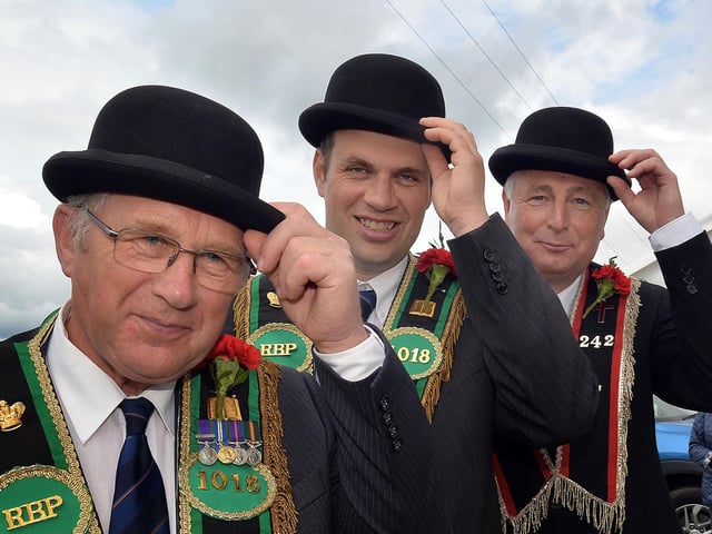 Bowled over...Tipping their bowler hats at the field during the RBP Last Saturday parade in Loughgall are from left, Basil Stubbs, Trevor Stubbs and David Wilson. TH12.