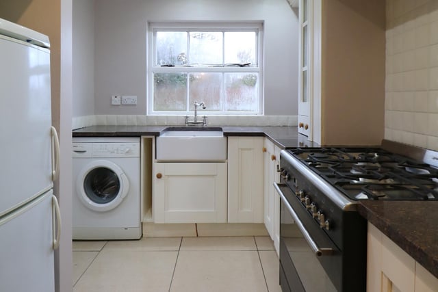 The modern fitted kitchen has a range of high and low level storage units and contrasting polished granite work surface. There is an inlaid ceramic sink with mixer tap, space for range oven and hob with extractor canopy over and fridge freezer.