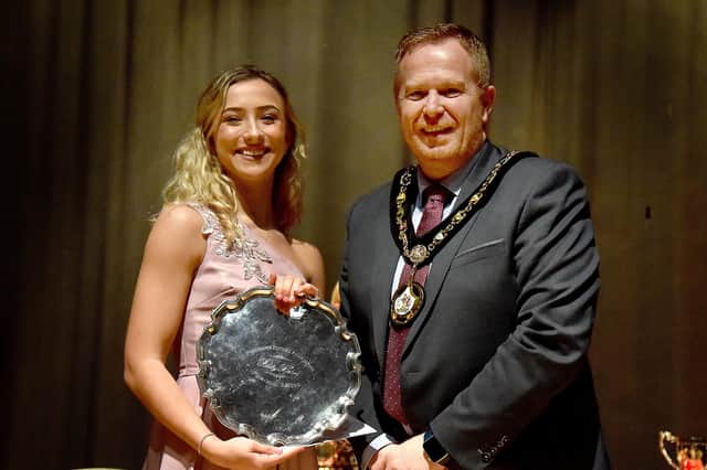 Amber Dickson receives the trophy for the Senior Vocal Solo Championship from Lord Mayor of ABC Council, Councillor Paul Greenfield. PT14-249.