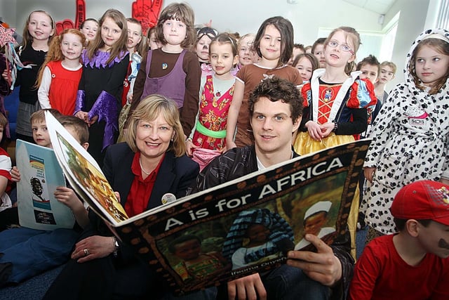 Belfast Giant Craig Peacock, Ann Broome of Tesco pictured with Ballinderry Primary School pupils in 2012