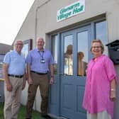 Outside the new door at Glenarm Village Hall, which was funded by the Housing Executive, are: John Read, Housing Executive Good Relations officer; Leslie Morrow, Glenarm Village Committee secretary and Francis Wilson, Glenarm Village Committee assistant chairperson. Photo submitted by the Housing Executive