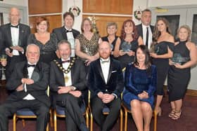 Some of the prizewinners and sponsors at the Carrick Business Excellence awards in 2021 including front row from left, Bob Harper, Lifetime Achievement Award winner, Mayor, Councillor William McCaughey from principal sponsor Mid & East Antrim Borough Council, compere, Barra Best and Jenny Small, VP of Performance and Development Northern Regional College. Also included third, back row, is Kelli McRoberts, manager with category sponsors Carrickfergus Enterprise. Picture: Tony Hendron