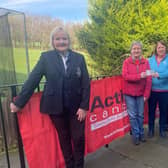 Action cancer representative Ann Lavery accepts the cheque from Lady member Denise McBrien.