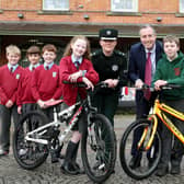 Education Minister Paul Givan pictured with PSNI District Commander, Chief Superintendent Kellie McMillan and pupils from Dromore Central Primary School and St Colman’s Primary School, Dromore at a presentation event for both schools who are involved in a cross-community bicycle project.
