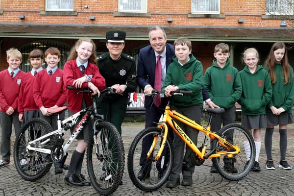 Education Minister Paul Givan pictured with PSNI District Commander, Chief Superintendent Kellie McMillan and pupils from Dromore Central Primary School and St Colman’s Primary School, Dromore at a presentation event for both schools who are involved in a cross-community bicycle project.