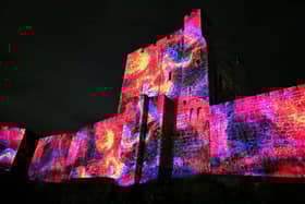 Carrickfergus Castle illuminated for the Passing Waves event.  Photo: Extern