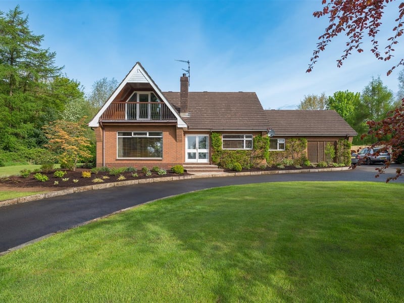 The detached family home occupies a mature, private site.