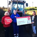 Rachel and Ruth Wright presenting a cheque to  Valerie Saunders, NICHS community fundraiser. Photo provided