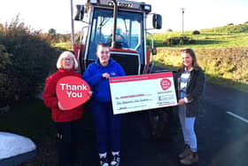 Rachel and Ruth Wright presenting a cheque to  Valerie Saunders, NICHS community fundraiser. Photo provided
