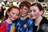 Celebrating the coronation with painted faces are, from left, Isla Speers (7), Saul Speers (10) and Annabeth Wright (9). PT18-227.