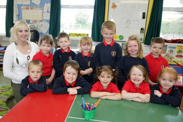 SIX AND FIVE. Teacher at Landhead PS Mrs Parke, pictured along with happy looking P1's in 2010