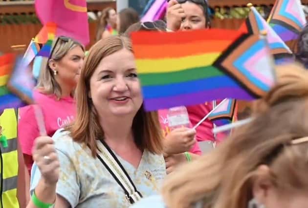 Head of the Northern Ireland Civil Service Jayne Brady waving a controversial Progress Flag in 2023.