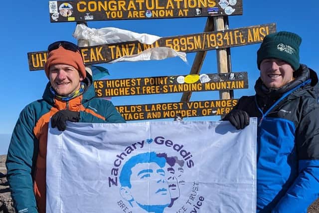 The Ballymoney men on top of Kilimanjaro with a ZGBTST banner. Credit CMcDonald/JHeggarty