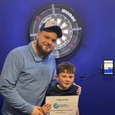 Danny Anderson from Ruthless Darts Co with nine year old Archie Anderson who won the first youth tournament in Lisburn. Pic credit: Ruthless Darts Co