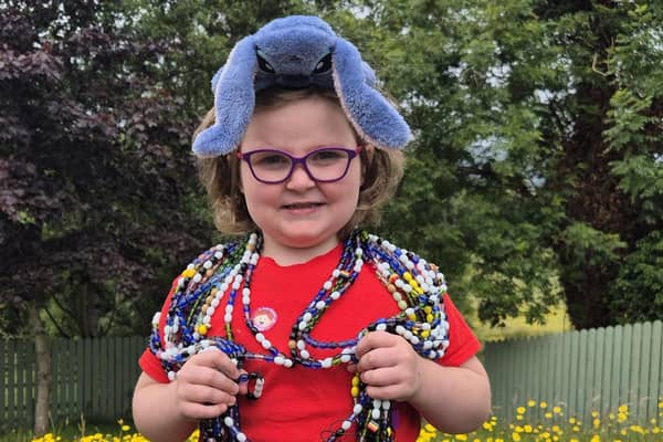 Freda was diagnosed with leukaemia in 2023, wearing her beads of courage, each bead represents a treatment , its her journey in beads and is about 23 meters long with a few meters to add. Credit:Supplied