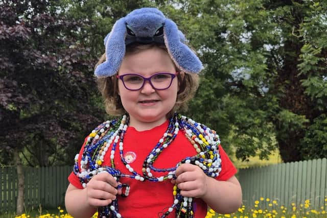Freda was diagnosed with leukaemia in 2023, wearing her beads of courage, each bead represents a treatment , its her journey in beads and is about 23 meters long with a few meters to add. Credit:Supplied