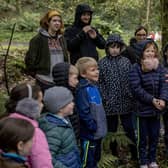 Staff and pupils from St Peter’s and St Paul’s Primary School Foreglen, with students from Ulster University School of Education, Museum Services volunteer, Rebekah Stewart, and facilitator Jim Allen preparing for hunting games in the woods.