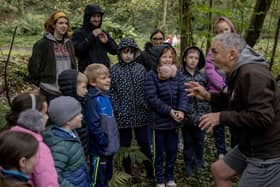 Staff and pupils from St Peter’s and St Paul’s Primary School Foreglen, with students from Ulster University School of Education, Museum Services volunteer, Rebekah Stewart, and facilitator Jim Allen preparing for hunting games in the woods.